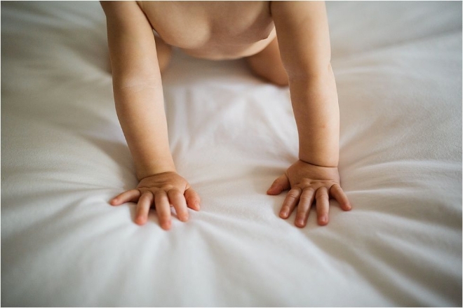 adoption cover image caucasian infant crawling on white blanket